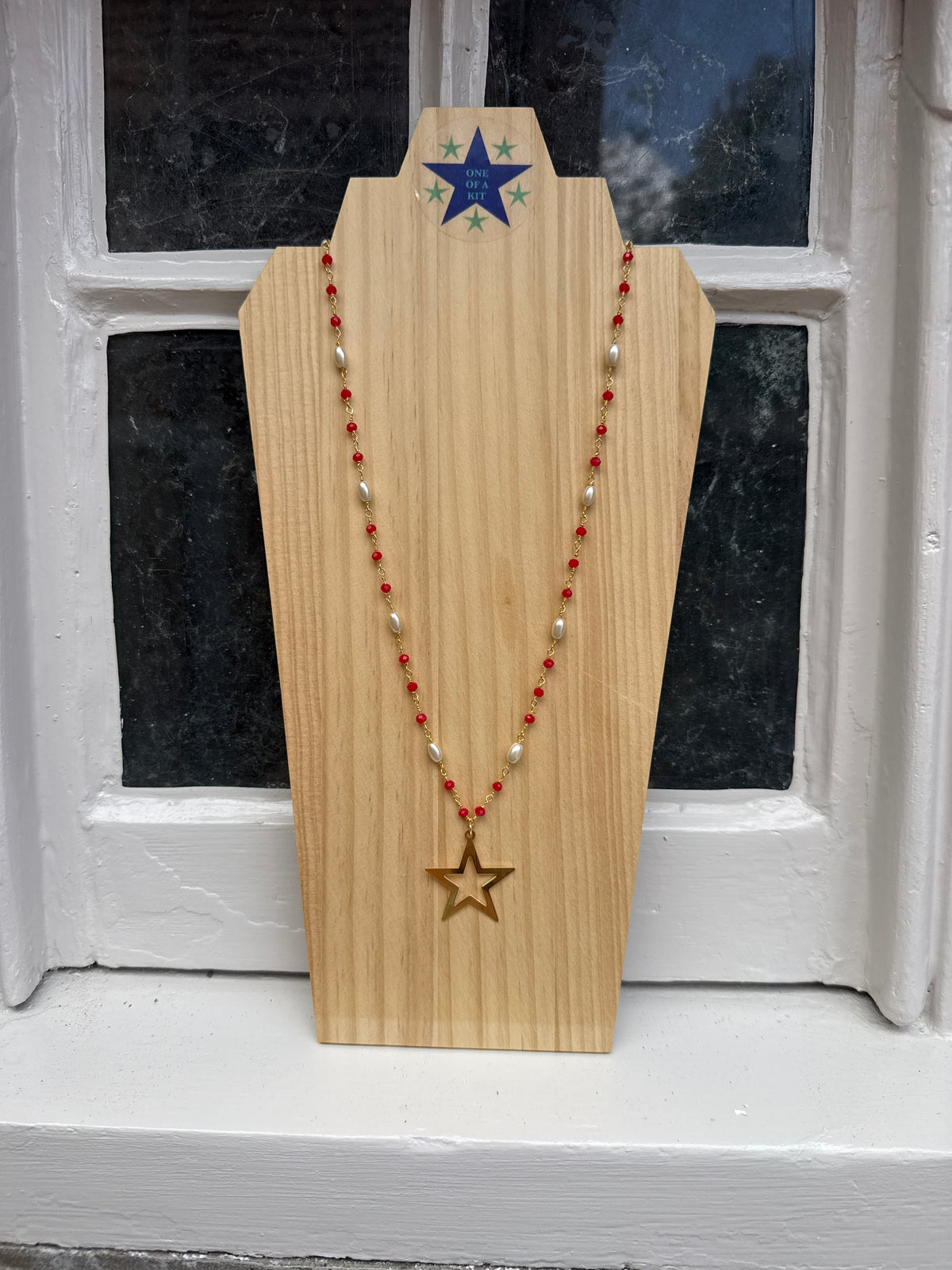 Long red and pearl star necklace